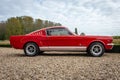 Side view of Classic car Ford Mustang, first generation, in red color at The Gallery Brummen