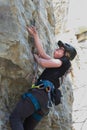 Side view of climber finding hand grip