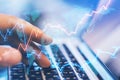 Side view and close up of hands using laptop on desktop with abstract forex chart. Fintech, trade and data exchange concept.