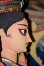 A side view close up portrait face of Goddess Durga idol, symbol of strength and slayer of evil and spirituality as per Hinduism.