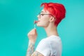 Side view close up portrait of stylish funny girl sticking the lollipop Royalty Free Stock Photo