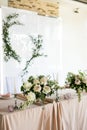 Side view of close up of presidium with fresh flowers of the newlyweds at the wedding