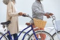 Couple holding bicycles by the beach Royalty Free Stock Photo