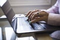 Side view close up of woman hands typing on laptop keyboard at corporate or home office. Businesswoman or student using laptop for Royalty Free Stock Photo