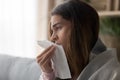 Side view close up woman holding paper tissue sneezing Royalty Free Stock Photo