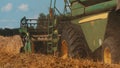 Side View Closeup Of Big Tires Of A Combine Harvester With Cutter Bar Ready To harvest Royalty Free Stock Photo