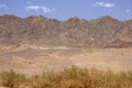 Side view of colorful mountains of Eilat against of blue sky with clouds Royalty Free Stock Photo