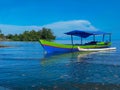 Colorful outrigger boat with a tranquil scene on Morowali beach Royalty Free Stock Photo