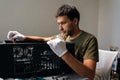 Side view of computer technician in protective gloves carefully installing internal hardware components inside open Royalty Free Stock Photo