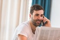 Side view of confident bearded dressed in white shirt looking at financial accountings while talking with business