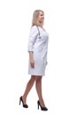 confident young woman doctor striding forward . isolated on a white background. Royalty Free Stock Photo