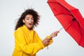 Side view of confused surprised african woman in raincoat