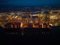 Side view of container ship lights at night at illuminated Southampton Docks aerial Royalty Free Stock Photo