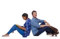 Side view of a couple of students who are sitting on the floor with their backs