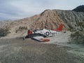 Side view of crashed Navy plane on small desert hill