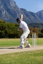 Side view of cricket player playing on field