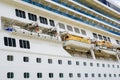 Side view of cruise ship with hanging lifeboats and liferafts, emergency rescue boats and rafts Royalty Free Stock Photo