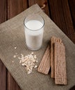 side view crunchy crispbread with oatmeal and glass of milk on wooden background