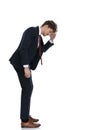 Side view of curious businessman looking down