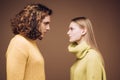 Side view. Curly man and blonde woman facing each other, eyes open. Concept of confrontation in the family. A couple Royalty Free Stock Photo