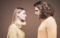 Side view. Curly man and blonde woman facing each other, eyes open. Concept of confrontation in the family. A couple Royalty Free Stock Photo