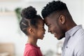 Side view of cute black father and daughter touching foreheads Royalty Free Stock Photo