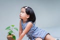 Side view of a cute girl sits lazily gazing upwards Royalty Free Stock Photo