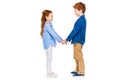 side view of cute happy children holding hands and smiling each other Royalty Free Stock Photo