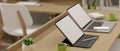 Side view, 3D rendering, portable workspace with two laptops and supplies on wooden table, 3D Illustration