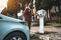 African guy charging an electric car