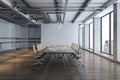 Side view on dark meeting table and wheel chairs under modern chandelier on top in spacious conference room with wooden floor, Royalty Free Stock Photo