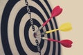 Side view of a dartboard with three darts in the bull's eye. Well-aimed dart throwing. A marksman's true hit. A triple bull's-e Royalty Free Stock Photo