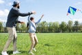 side view of daughter and father flying kite