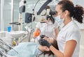 Side view of dentist in process of working in dental office