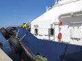 Side view of details of deck of tug boat docked at port dock. Professional boat for port work. Large tugboat berth in the port. Royalty Free Stock Photo