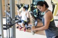 Determined young woman exercising cable rope triceps extension Royalty Free Stock Photo