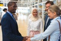 Business people interacting with each other in corridor at office Royalty Free Stock Photo