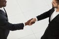 Side view diverse businessmen in suits shaking hands Royalty Free Stock Photo