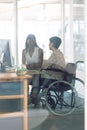 Female graphic designers interacting with each other at desk in a modern office Royalty Free Stock Photo