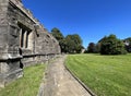 Side view, down the side of a stone church, St Mary the Virgin in, Gisburn, Lancashire, UK