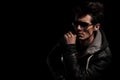 Side view of a dramatic man in leather jacket and sunglasses Royalty Free Stock Photo