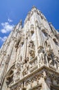 Side view of the Duomo with white walls, high windows, spires, and moulding. Milan, Italy Royalty Free Stock Photo