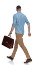 Side view of eager casual holding briefcase Royalty Free Stock Photo