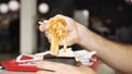 Side view of eating noodles with vegetables with chopsticks. Media. Close up of man eating vegetarian asian dish, wok Royalty Free Stock Photo