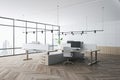 Side view on eco style coworking office with modern computers on light work tables on wooden parquet, white walls on background, Royalty Free Stock Photo