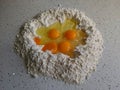Side view of eggs in a flour as a process of baking