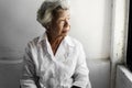 Side view of elderly asian woman with thoughtful face expression Royalty Free Stock Photo