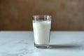 Side view elegance Glass of milk on white table, gray background