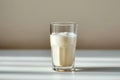 Side view elegance Glass of milk on white table, gray background