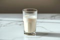 Side view elegance Glass of milk on white table, gray background